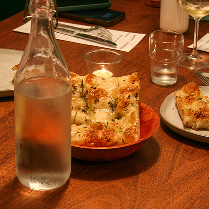 table with pizza slice and glasses